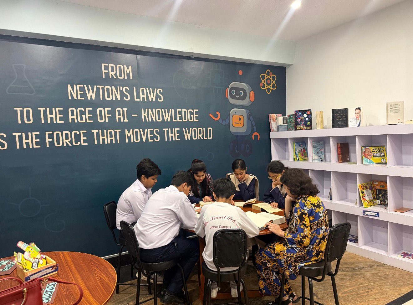 Students studying under the Newton's Laws to the Age of AI mural