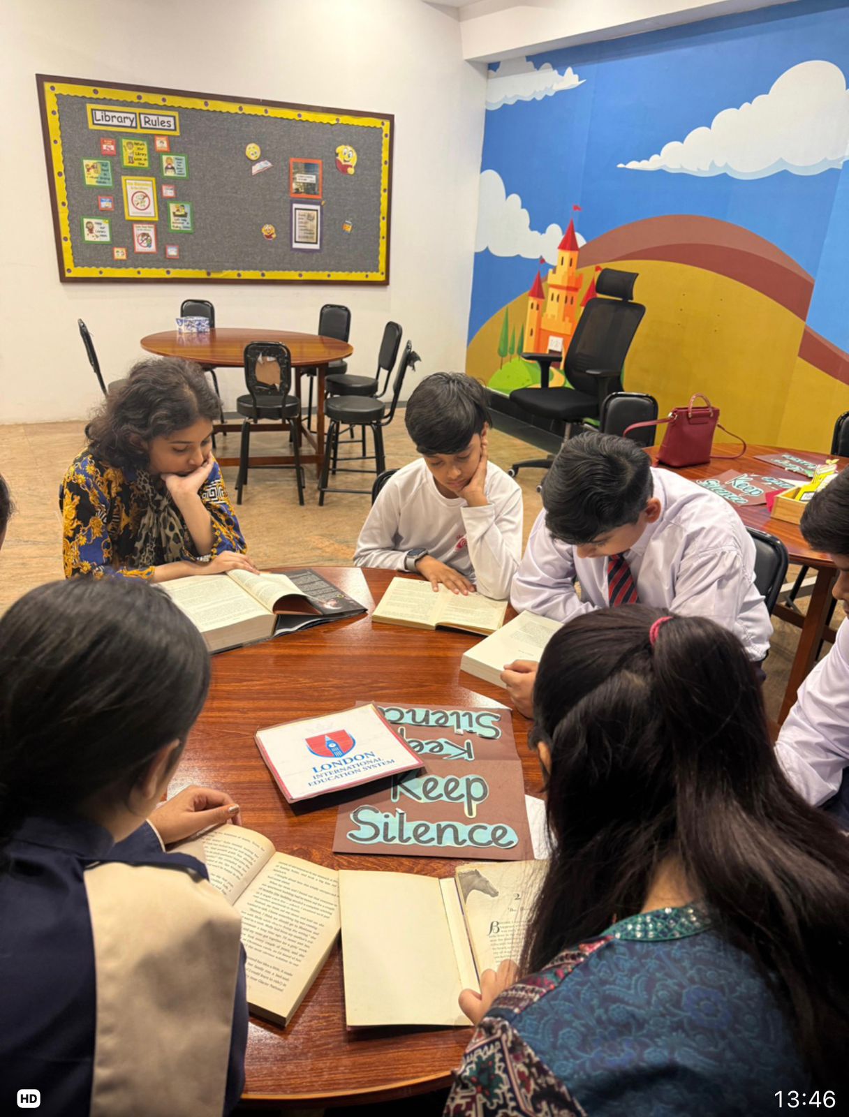 Students reading together at the library table