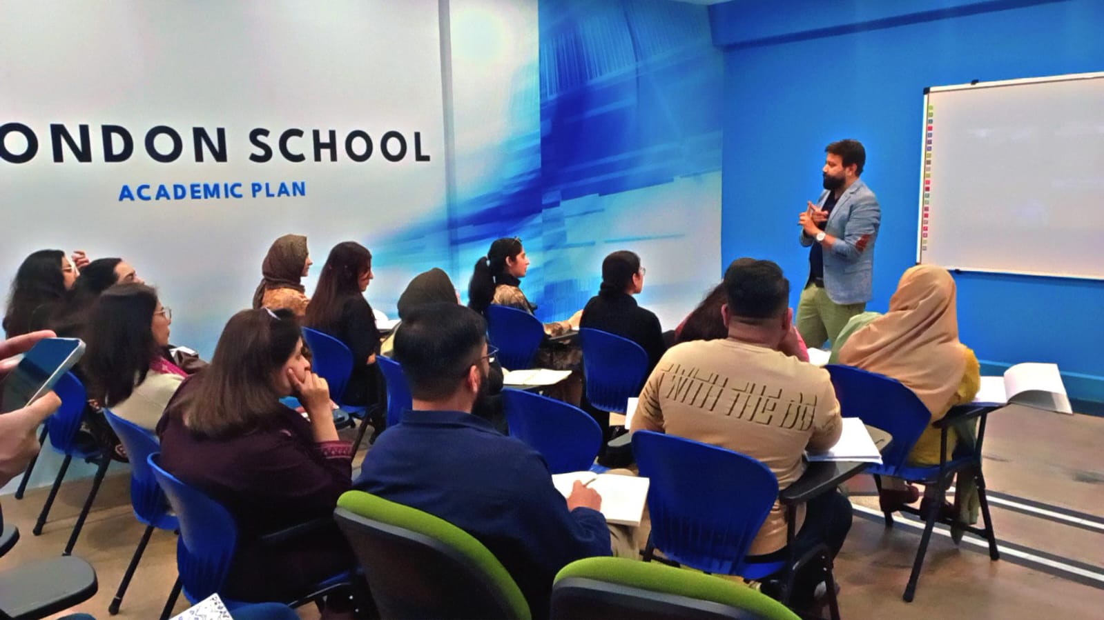 Presenter at whiteboard in training session