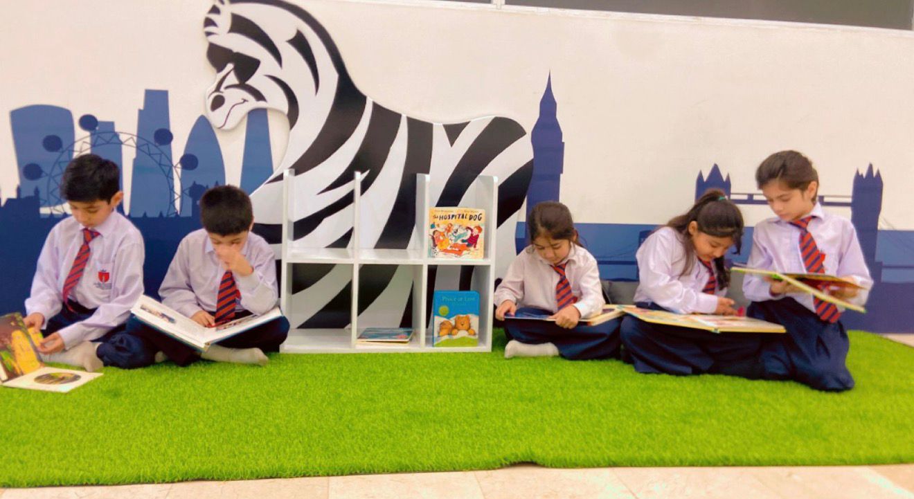Children reading in the library reading corner