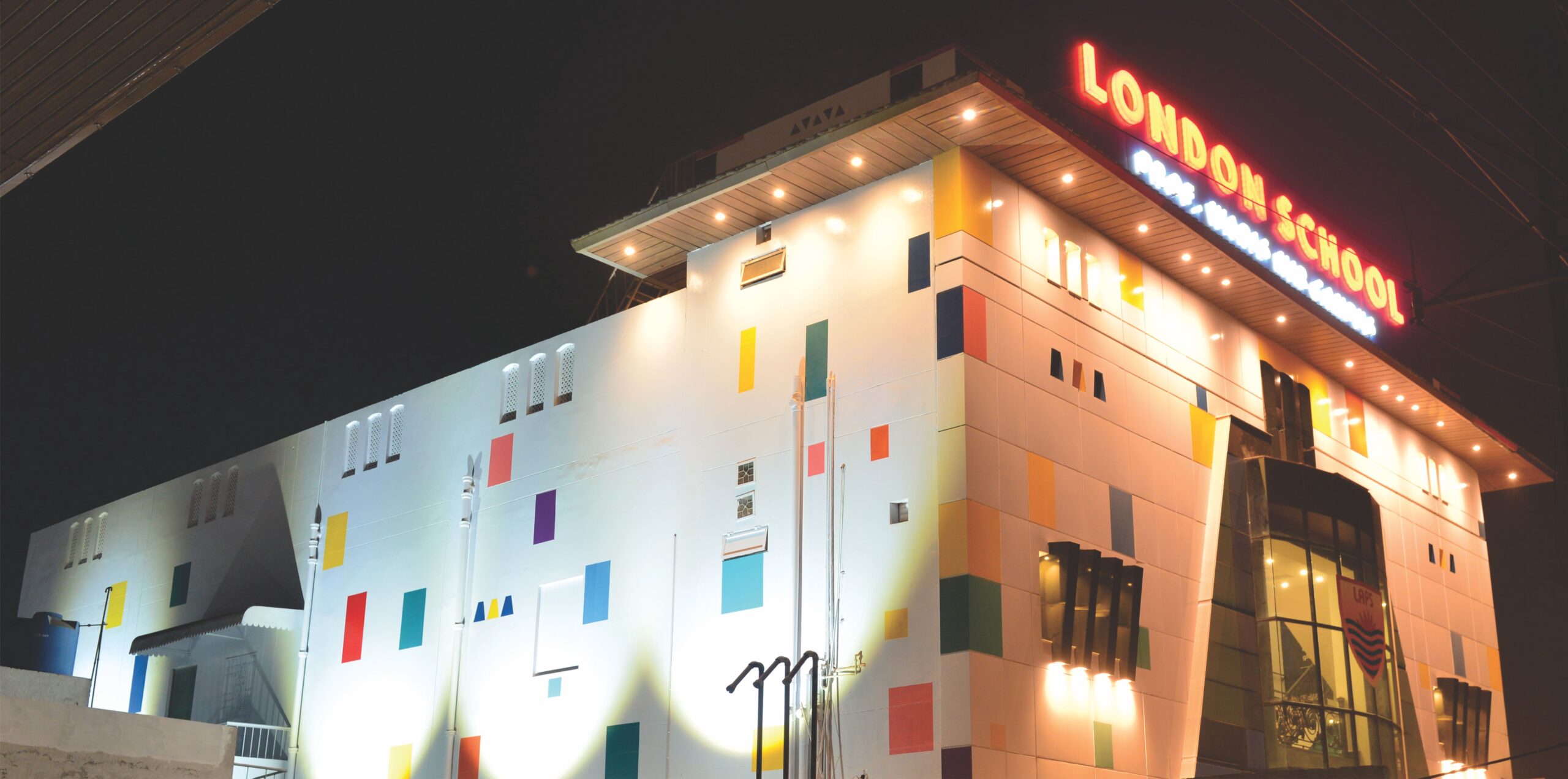 School building warmly lit at night